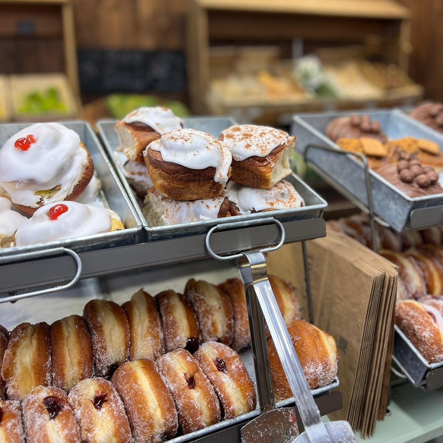 Doughnut display featuring jam doughnuts and sweet iced buns