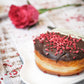 Raspberry Velvet Doughnut ball doughnut oozing with sweet raspberry jam & dipped in rich dark chocolate