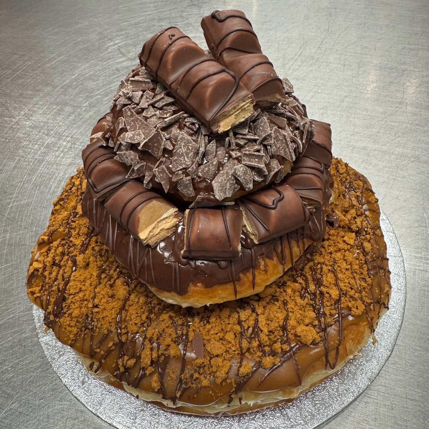 A chocolate doughnut stack with biscoff and kinder bueno