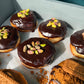 A tray of chocolate covered doughnuts