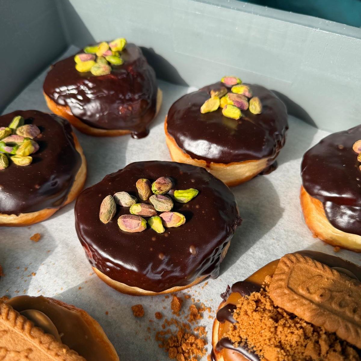 A tray of chocolate covered doughnuts