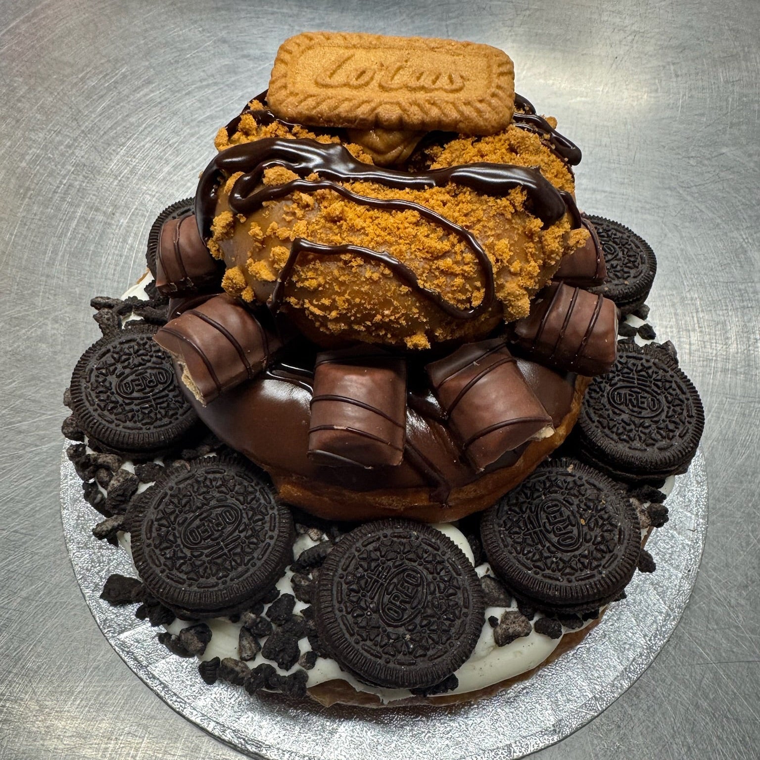 A doughnut cake made from Oreo, kinder bueno and biscoff doughnuts