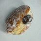 A doughnut dusted with sugar and filled with Nutella.