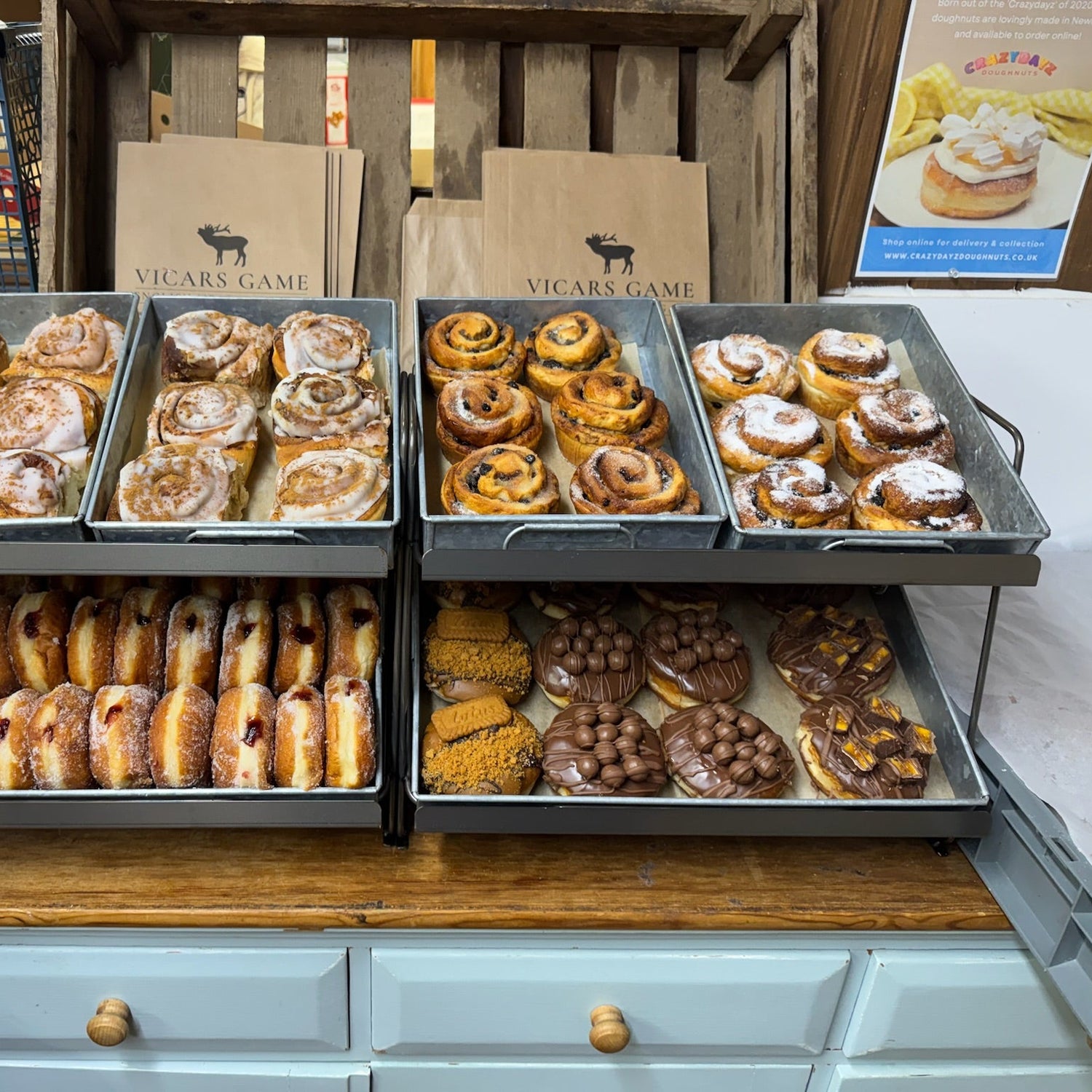 A display of various pastries and doughnuts in rustic trays