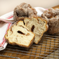 A cinnamon bun cut in half with cinnamon sugar swirled throughout