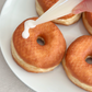 Icing a fresh ring doughnut with a DIY doughnut kit