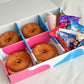 DIY doughnut kit box with 4 fresh ring doughnuts, icing and toppings