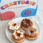 DIY doughnut kit, fresh ring doughnuts topped with delicious icing and biscuity favourites