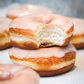Delicious fresh ring doughnuts with classic iced glazing