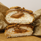 The inside of a lotus biscoff doughnut with biscoff cream oozing out the centre
