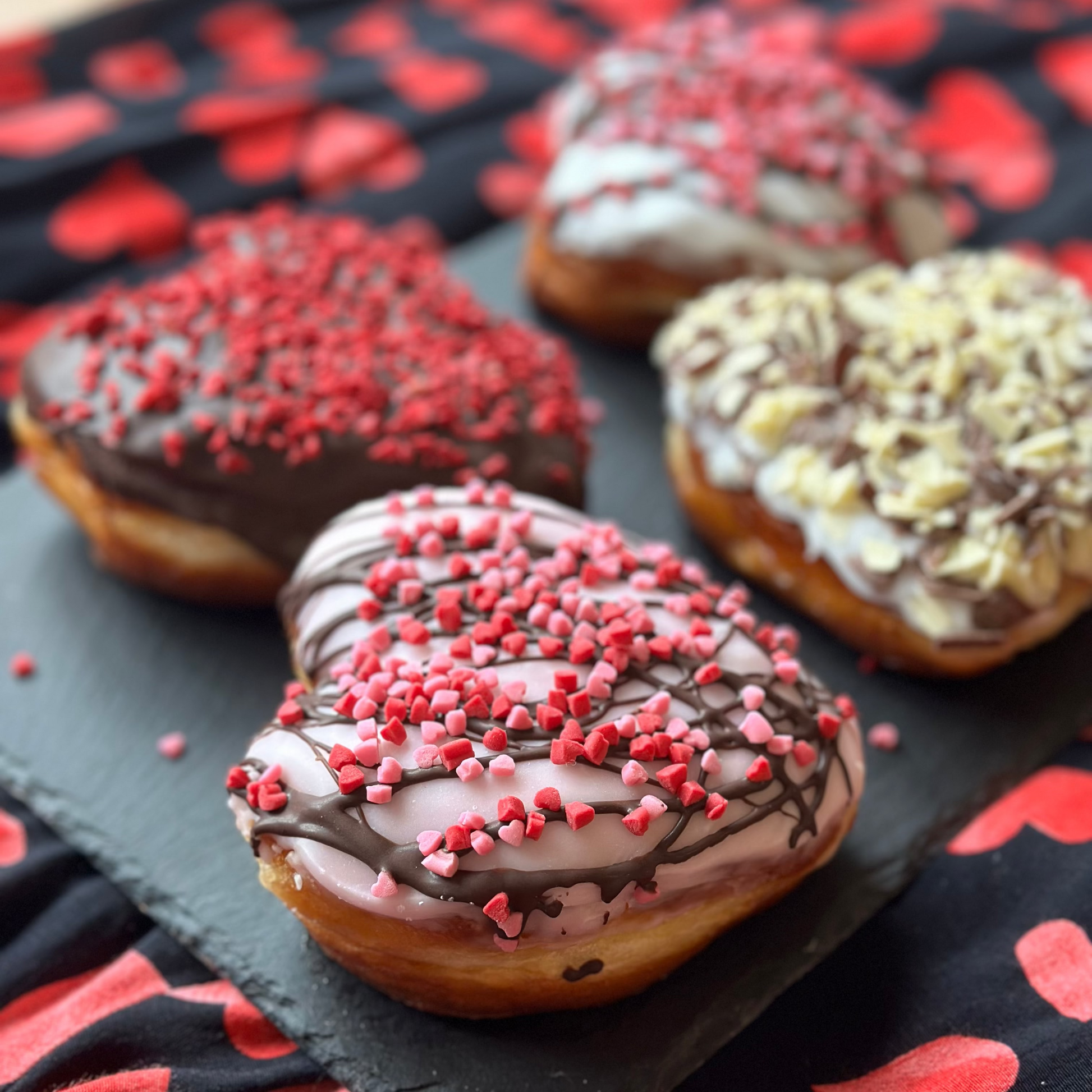 colourful heart shaped doughnuts in a valentine's setting